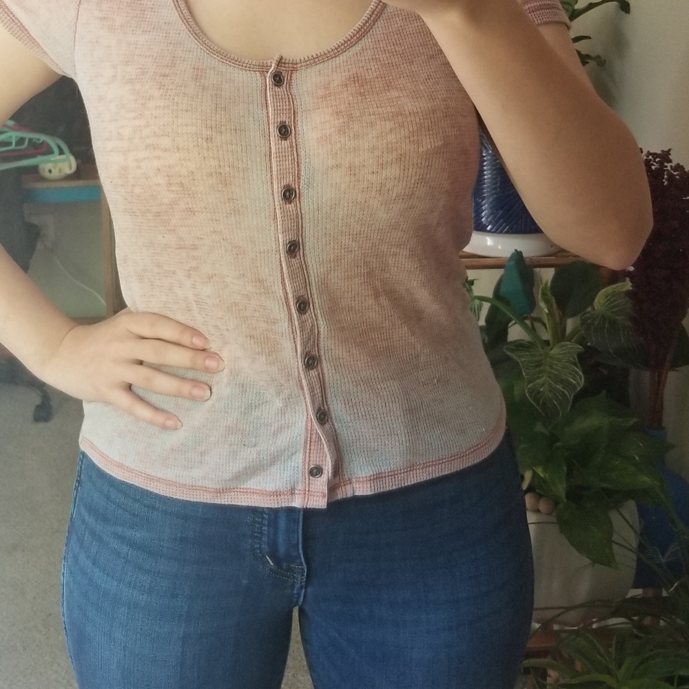 Distressed pink tee.